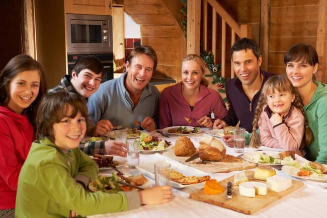 Happy host family eating together 