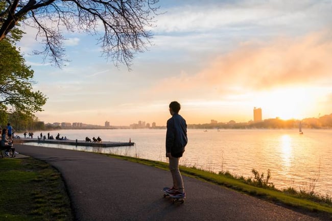 student skating near a river in Boston