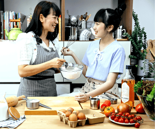 Host and student cooking together
