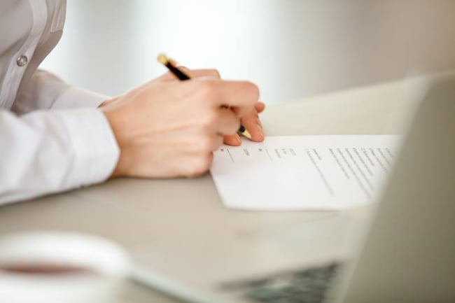 Closeup of student signing lease