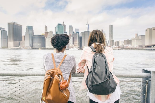 Two students overlooking city skyline