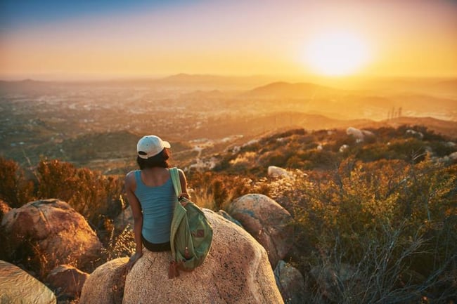 Student Sitting on a rock overlooking San Diego