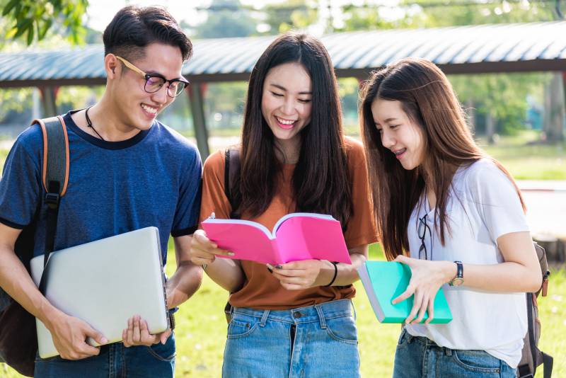 Three exchange students outside together