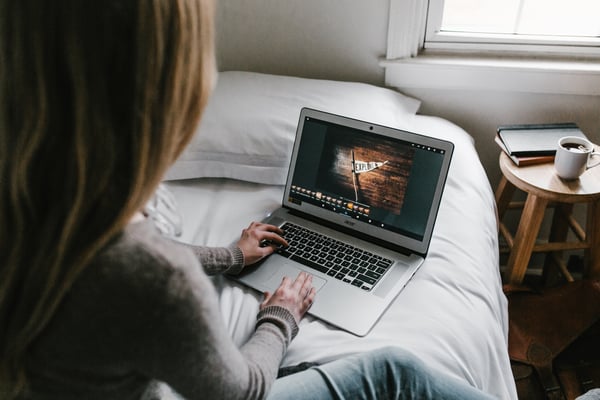 young woman on laptop looking up recipes