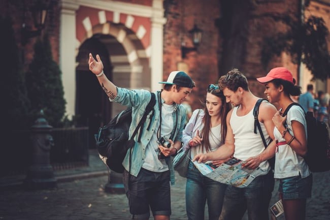 group of sudents travelling with a map