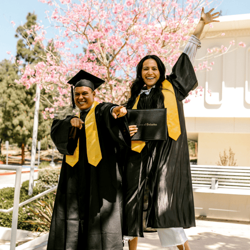 two students celebrating graduation