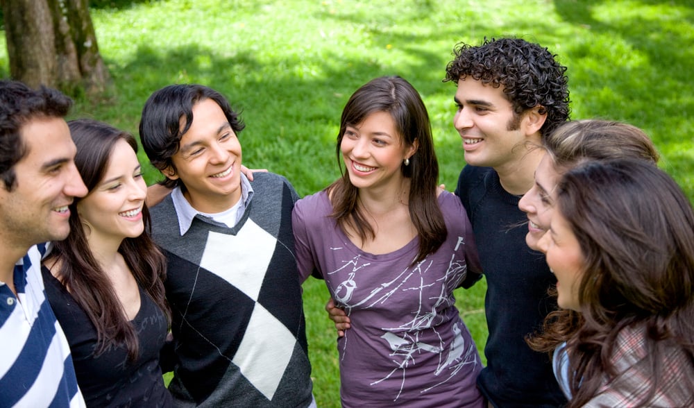 international students talking in a park