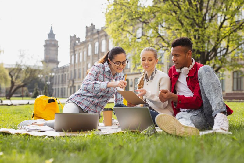 Student Sitting Outside on Campus Studying